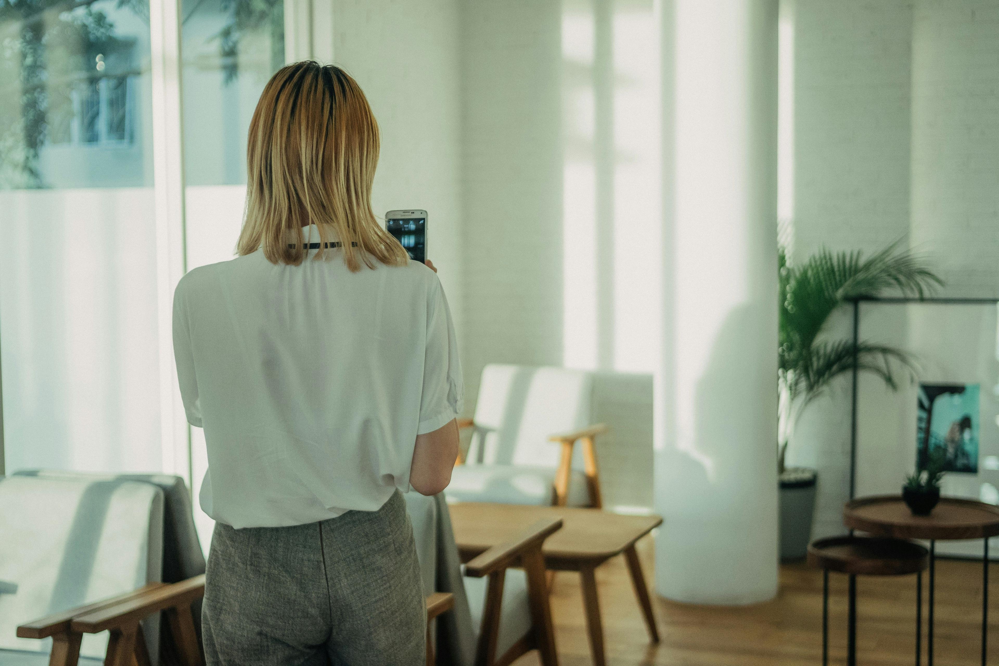 woman is calling a plumber on her mobile phone